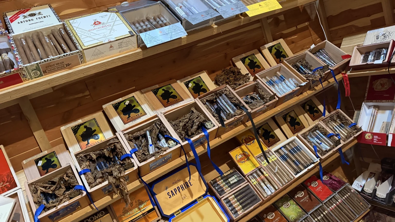 Assorted boxed cigars displayed in the cigar retail area at Julian Tobacco & Vape